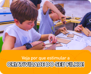 A imagem apresenta duas crianças concentradas na construção de um projeto manual, manuseando ferramentas. Na parte inferior da imagem, existe um retângulo laranja com o título "Veja por que estimular a criatividade do seu filho".